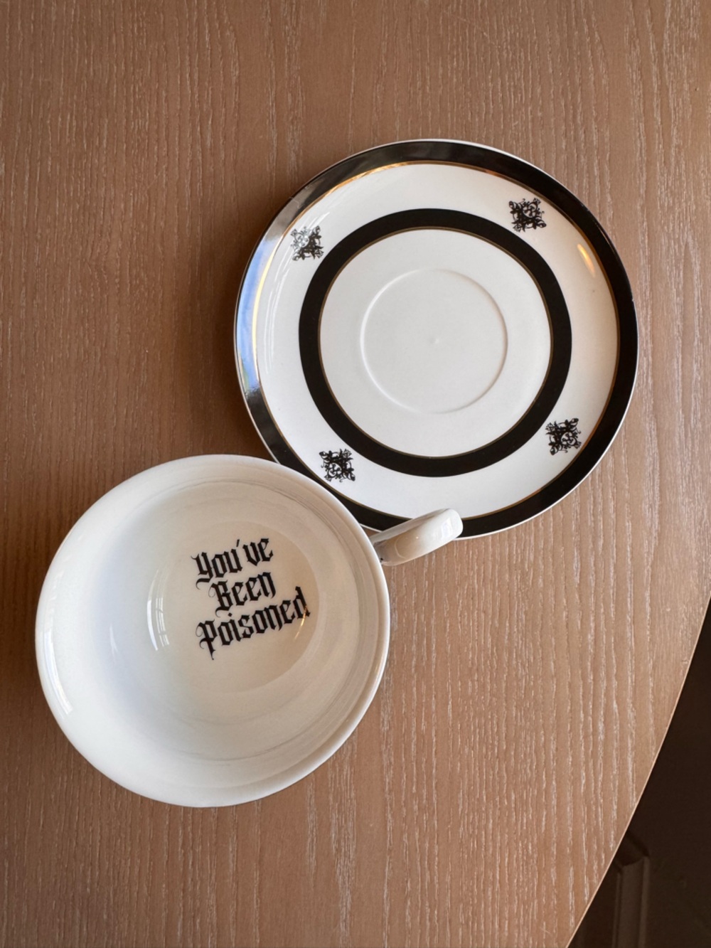 Black Trim Porcelain Saucer and White Teacup with Gothic Script